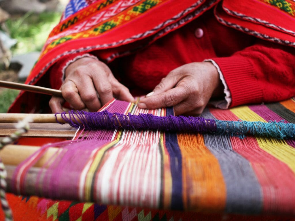 Local woman weaving textiles, Peru